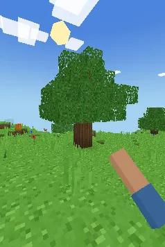 Große Eiche aus Würfeln auf einer grünen Wiese, blauer Himmel und eckige Wolken, mit dem Arm des Spielers im Vordergrund